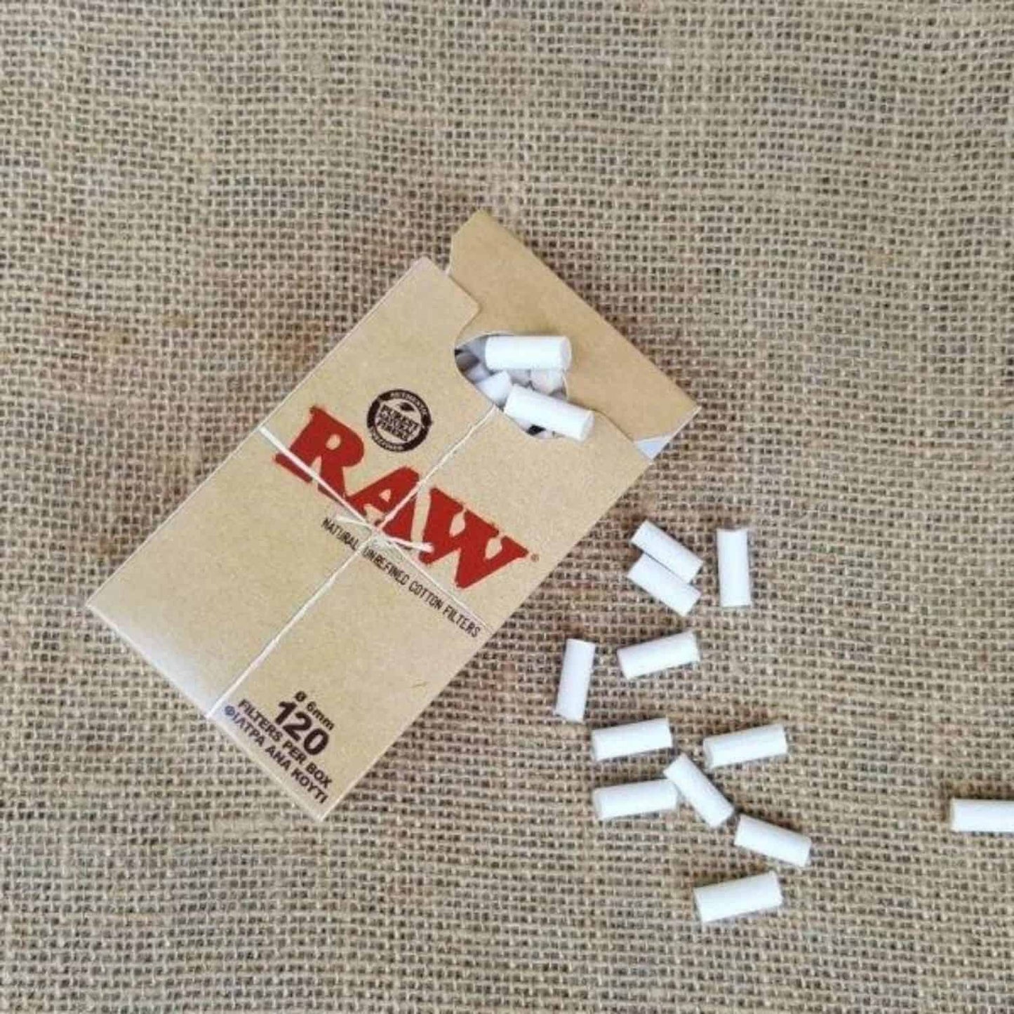 raw cotton filter tips box open pack with scattered filters