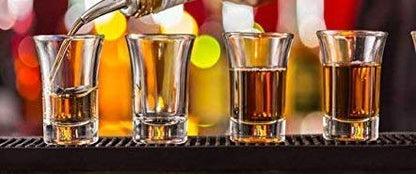 Shot glasses in bar with liquor